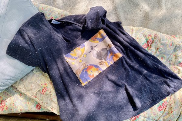 Blue Gather Threads t-shirt lying flat with dancing lady collage